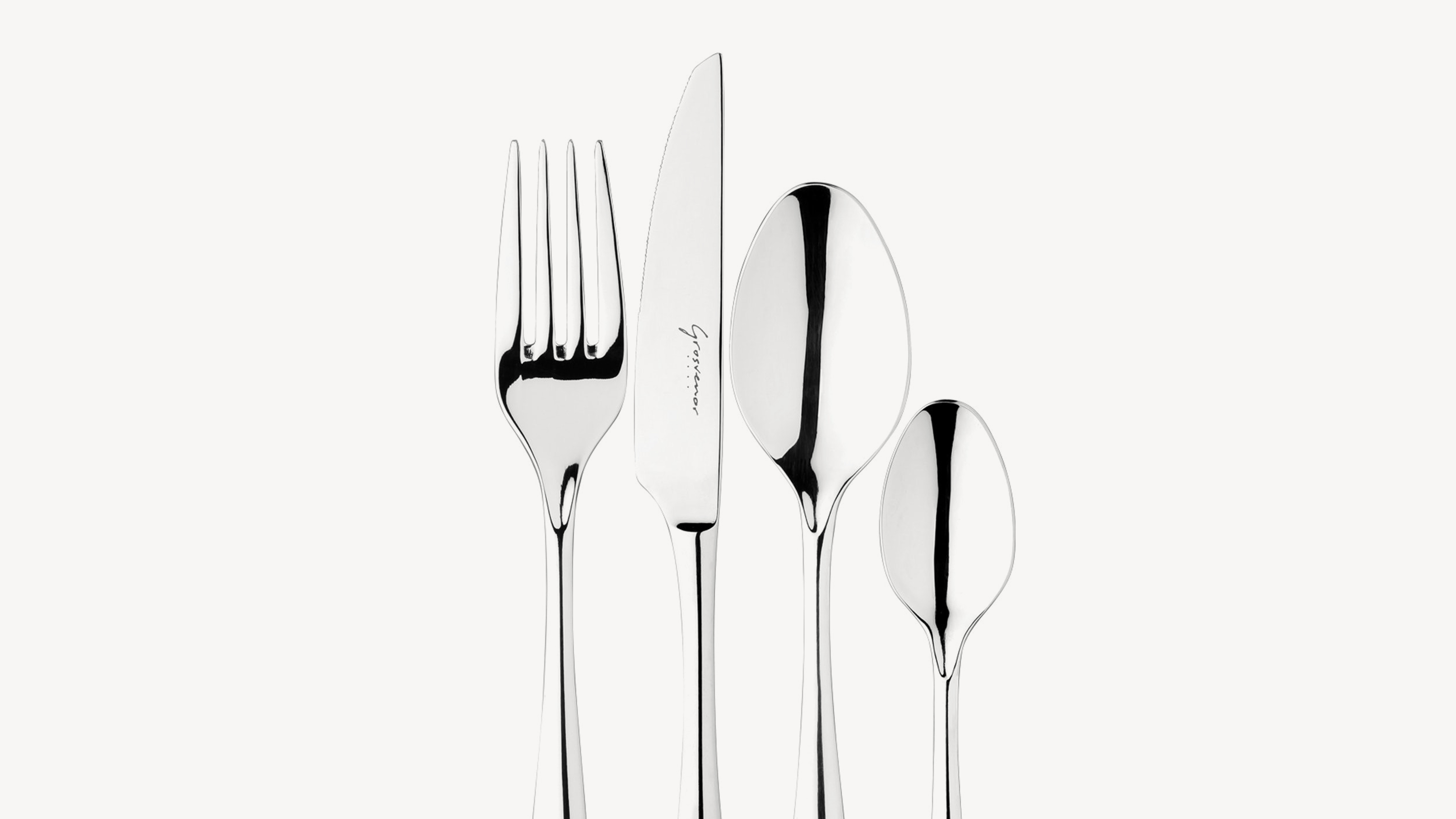 Grosvenor. Logotype hand lettering. Photo of cutlery: Fork, knife, table spoon, tea spoon. 